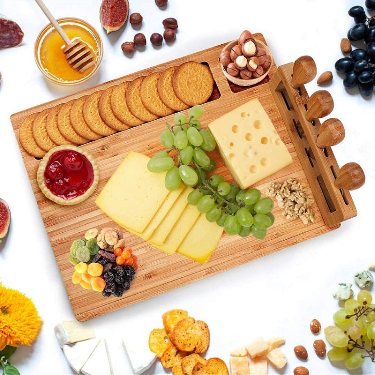 bamboo charcuterie board with knives for hosting